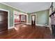 Bright living room features hardwood floors, a charming brick fireplace, and doorway to another room at 1434 Se Silver Springs Pl, Ocala, FL 34471