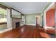 Spacious living room features hardwood floors, a brick fireplace, and ample natural light at 1434 Se Silver Springs Pl, Ocala, FL 34471