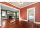 Inviting living room featuring a brick fireplace, hardwood floors, and natural light at 1434 Se Silver Springs Pl, Ocala, FL 34471