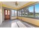 Light-filled sunroom with panoramic windows providing scenic views and access to the outdoors at 1434 Se Silver Springs Pl, Ocala, FL 34471