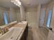 Bathroom featuring double sink vanity, a tub, and a private toilet at 15055 Sw 25Th Cir, Ocala, FL 34473
