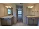 Modern bathroom featuring double vanity, granite counters, and sleek gray cabinetry at 15055 Sw 25Th Cir, Ocala, FL 34473