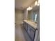 Stylish bathroom with double vanity, granite counters, and sleek gray cabinetry at 15055 Sw 25Th Cir, Ocala, FL 34473
