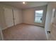 Well-lit bedroom with cozy carpeting, double door closet, and a bright window at 15055 Sw 25Th Cir, Ocala, FL 34473