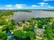 Expansive lakefront property featuring a custom home surrounded by mature trees and waterfront access at 15621 Se 103Rd Ter, Summerfield, FL 34491