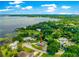 Expansive lakefront property with lush greenery and a private waterfront setting in a desirable neighborhood at 15621 Se 103Rd Ter, Summerfield, FL 34491
