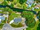Aerial view of the property showing the home's location on a waterfront lot with mature trees at 15621 Se 103Rd Ter, Summerfield, FL 34491