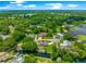 Aerial view of home on waterfront property with lush greenery, canal access, and neighborhood amenities at 15621 Se 103Rd Ter, Summerfield, FL 34491