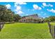 Expansive backyard featuring lush green lawn and a charming two-story home with a wooden deck at 15621 Se 103Rd Ter, Summerfield, FL 34491