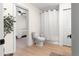 Bright bathroom with shower, toilet, and view into the bedroom through an open doorway at 15621 Se 103Rd Ter, Summerfield, FL 34491