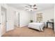 Bedroom featuring neutral carpet, ceiling fan and a walk-in closet at 15621 Se 103Rd Ter, Summerfield, FL 34491