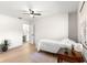 Cozy bedroom featuring natural light from the window and complemented by wood-look flooring and modern ceiling fan at 15621 Se 103Rd Ter, Summerfield, FL 34491