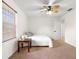 Neutral bedroom featuring a window with blinds, side table, and ceiling fan at 15621 Se 103Rd Ter, Summerfield, FL 34491