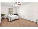 Bedroom featuring neutral carpet, a ceiling fan, and natural light from the window at 15621 Se 103Rd Ter, Summerfield, FL 34491