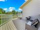 Outdoor seating on the deck offers a peaceful retreat to enjoy the backyard and surrounding natural beauty at 15621 Se 103Rd Ter, Summerfield, FL 34491