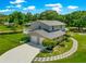 Back exterior of home featuring a balcony, a two car garage and green backyard at 15621 Se 103Rd Ter, Summerfield, FL 34491