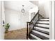 Charming foyer showcases stone floors, staircase with wood railing, and convenient coat closet at 15621 Se 103Rd Ter, Summerfield, FL 34491