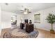 Home office featuring a dark wood desk, ceiling fan, neutral walls, and natural light from the window at 15621 Se 103Rd Ter, Summerfield, FL 34491