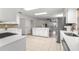 Open kitchen featuring a large island, white cabinets, and views into the spacious living area at 15621 Se 103Rd Ter, Summerfield, FL 34491