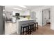 Bright kitchen featuring an island with seating, white cabinetry, and stainless steel appliances at 15621 Se 103Rd Ter, Summerfield, FL 34491