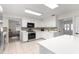 Spacious kitchen featuring white cabinets, stainless steel appliances, and an open layout at 15621 Se 103Rd Ter, Summerfield, FL 34491