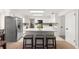 Well-lit kitchen with a central island, white cabinetry, and stainless-steel appliances for the home chef at 15621 Se 103Rd Ter, Summerfield, FL 34491