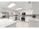 Bright kitchen with stainless steel appliances, white cabinetry, and tile backsplash at 15621 Se 103Rd Ter, Summerfield, FL 34491