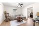 Living room featuring hardwood floors, a ceiling fan, a rocking chair, and a sofa with natural light at 15621 Se 103Rd Ter, Summerfield, FL 34491