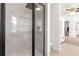 The sleek marble shower with black trim provides a modern touch and enhances the bathroom's design at 15621 Se 103Rd Ter, Summerfield, FL 34491