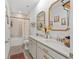 Well-lit bathroom with double sink vanity, gold fixtures, and decorative mirrors at 1814 Nw 44 Court Rd, Ocala, FL 34482
