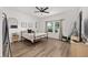 Bright bedroom with neutral walls, light-colored hardwood floors, and a window view at 1814 Nw 44 Court Rd, Ocala, FL 34482