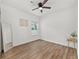 Empty bedroom boasts wood floors, a neutral wall color, and a large window at 1814 Nw 44 Court Rd, Ocala, FL 34482