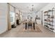 Open-concept dining area with stylish lighting and decor, connecting seamlessly to the kitchen and living spaces at 1814 Nw 44 Court Rd, Ocala, FL 34482