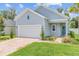 Charming one-story home boasts a brick driveway, two-car garage, and lovely landscaping, perfect for curb appeal at 1814 Nw 44 Court Rd, Ocala, FL 34482