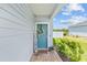 Inviting front porch with a blue door, a wreath, and a 'Hey Friends' sign, creating a warm welcome at 1814 Nw 44 Court Rd, Ocala, FL 34482