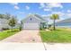 Attractive single-Gathering home with a paver driveway, manicured lawn, and stylish facade at 1814 Nw 44 Court Rd, Ocala, FL 34482
