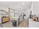 Modern, bright kitchen with white cabinets, a large island, stainless appliances, and an adjoining dining area at 1814 Nw 44 Court Rd, Ocala, FL 34482