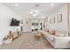 Spacious living room with natural light, neutral tones, and access to the outdoor patio for seamless indoor-outdoor living at 1814 Nw 44 Court Rd, Ocala, FL 34482
