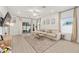 Bright living room features tile floors, neutral walls, and a large comfy couch at 1814 Nw 44 Court Rd, Ocala, FL 34482