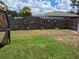 Fenced backyard features hanging planters, garden art, and mature landscaping for a tranquil outdoor space at 21511 Sw Plantation Sw St, Dunnellon, FL 34431