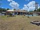 Extensive backyard with a pool, gazebo, screened patio, and firepit area, great for outdoor entertaining at 21511 Sw Plantation Sw St, Dunnellon, FL 34431