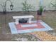 Backyard featuring a stone bench, decorative plantings, and tiled patio at 21511 Sw Plantation Sw St, Dunnellon, FL 34431