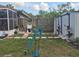 The backyard features garden art, shed, screened porch, and manicured lawn at 21511 Sw Plantation Sw St, Dunnellon, FL 34431