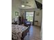 The bedroom has a comfortable chair with exterior view, side table, and floral comforter at 21511 Sw Plantation Sw St, Dunnellon, FL 34431