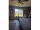 Cozy bedroom with a large window overlooking the backyard at 21511 Sw Plantation Sw St, Dunnellon, FL 34431