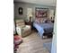 Bedroom with sitting chair, bed, and colorful pillows, decorated with clock and art at 21511 Sw Plantation Sw St, Dunnellon, FL 34431