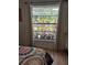Bedroom window with backyard full of potted plants and a colorful patio at 21511 Sw Plantation Sw St, Dunnellon, FL 34431