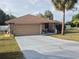 Charming home featuring a stone facade, a spacious driveway, and a well-maintained yard at 21511 Sw Plantation Sw St, Dunnellon, FL 34431