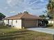 Charming home featuring a stone facade, a spacious driveway, and a well-maintained yard at 21511 Sw Plantation Sw St, Dunnellon, FL 34431