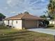 Charming home featuring a stone facade, a spacious driveway, and a well-maintained yard at 21511 Sw Plantation Sw St, Dunnellon, FL 34431